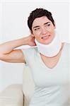 Close up of a short-haired woman with a surgical collar in a waiting room