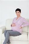 Pregnant woman sitting on a sofa in a waiting room