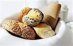 basket full of small breads with various seeds