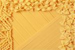 On a background of spaghettis there are different kind of pasta