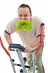 Power slimming concept with overweight man on exercise machine eating fresh green salad - isolated