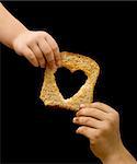 Sharing food with the needy - kids hands with a slice of bread