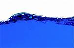 Blue water with air bubbles in the water line. Focus on the water line.