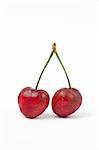 Two sweet cherries on white background