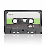 Vintage c-cassette audio tape on white with natural reflection.