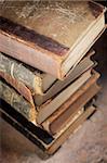 A Stack of old worn and tattered books. Short depth-of-field.