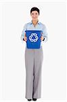 Businesswoman showing a recycling bin against a white background