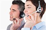 Close up of operators speaking through headsets against a white background