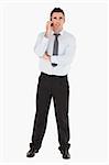 Businessman using a mobile phone against a white background