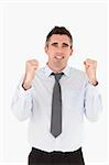Portrait of a cheerful businessman with the fists up against a white background
