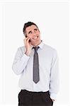 Portrait of a smiling man making a phone call against a white background