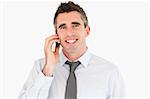 Smiling man making a phone call against a white background