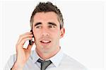 Close up of a businessman making a phone call against a white background