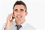 Close up of a happy businessman making a phone call against a white background