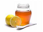 A jar of honey, lemons and spoon. Isolated on white background.