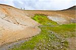 A hot spring emerging from the sides of a volcano caldera in the active Krafla system near Myvatn, Iceland