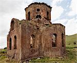 Landscape of Kizil Kilsie with rolling hills, Red Church ruins of dilapidated and derelict Church Cappadocia Turkey dating to the 6th century, red limestone, horizontal, crop area and copy space