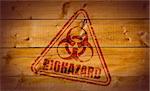 Biohazard stamp on wooden background.