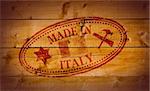 Made in Italy rubber stamp on wooden background.