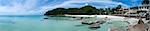 panorama of tourists enjoying the clear shallow sea on secluded beach near lamai in koh samui island thailand