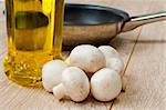 Fresh mushrooms, olive oil and a frying pan