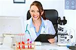 Smiling medical doctor woman working in office