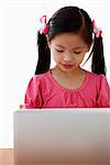 Young Chinese girl looking at laptop
