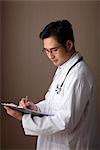 Profile of male doctor holding clipboard