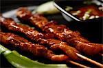 Beef satay with dipping sauce.