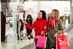 Pair of young women window shopping