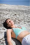 Woman lying on rock