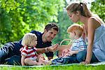 Mid adult parents with children on picnic