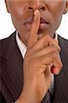 This is an image of businessman with his hands on his lips. This posture implies secrecy, illegal business, trust etc..