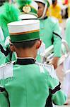 Young band member in a green uniform before a performance