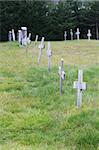 Line of wooden crosses at the countryside graveyard