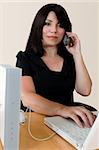 A woman making a wireless internet phone call via a wirless modem router.