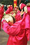 Chinese New Year celebrations in Qingdao, China - a woman plays a musical instrument on the second day of the week-long vacation.