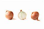 Two onions and a half on white background.