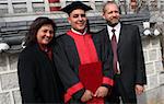 Happy graduate with his mother and father.