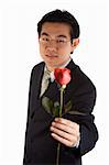 Asian young guy holding roses for proposing.