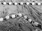 Detail shot of old fishing net rope lying on a quay