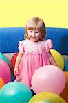 portrait of cute little girl with balloons, with copy space on top