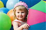 portrait of cute little girl with colorful umbrella and balloons