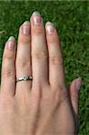 Close up of a hand with engagement ring.