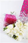 Flowers, candle and a gift bag for a birthday or other special occasion - isolated.