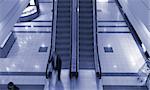 People on escalator in shopping center