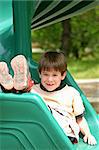 Boy on Green Slide Smiling