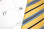 A tie and calendar showing father's day.