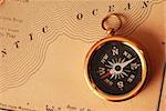 Antique brass compass over old USA map background