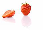 full strawberry and half isolated over white with reflection